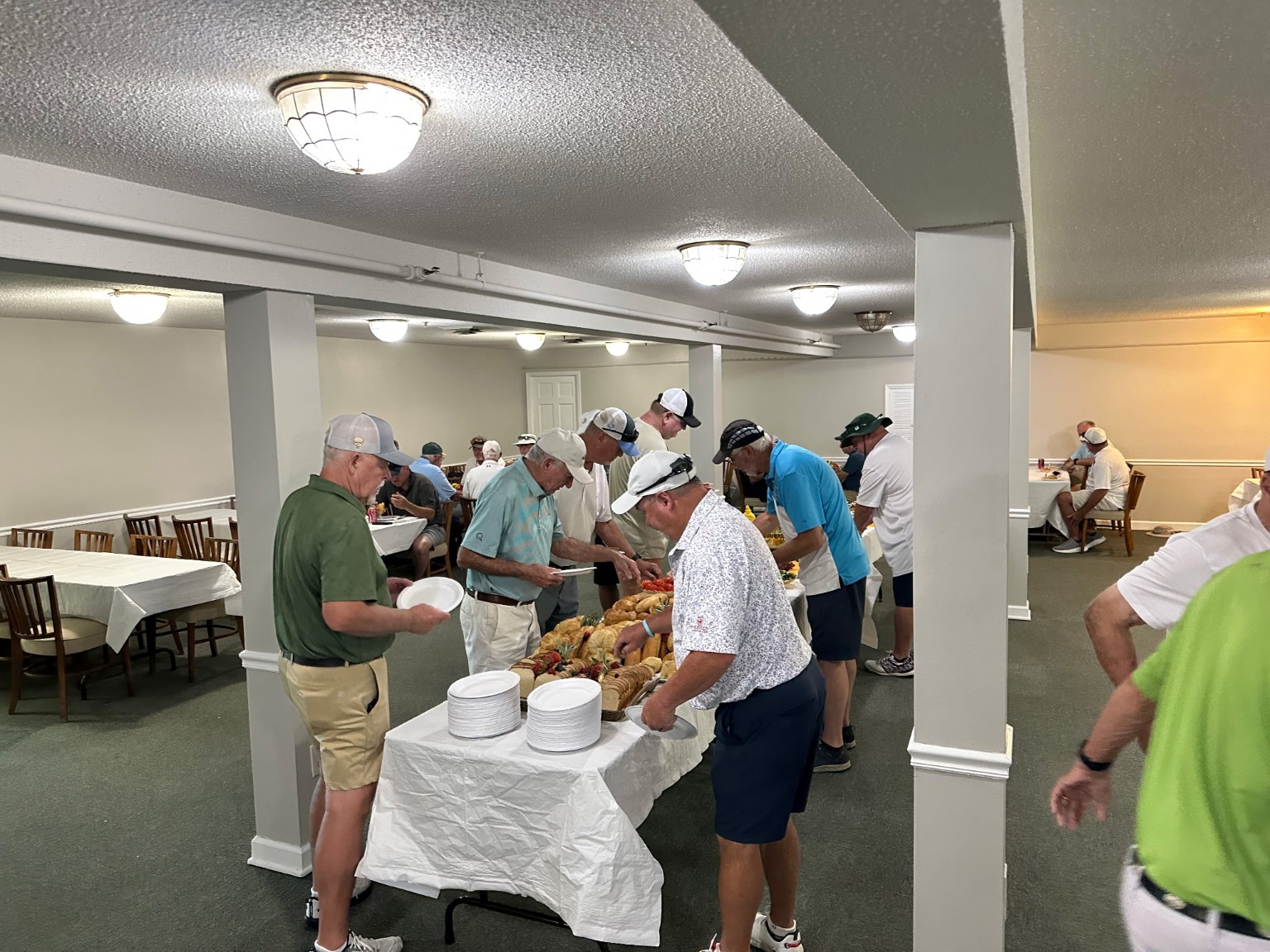 Golf tournament meal setup with attendees serving food