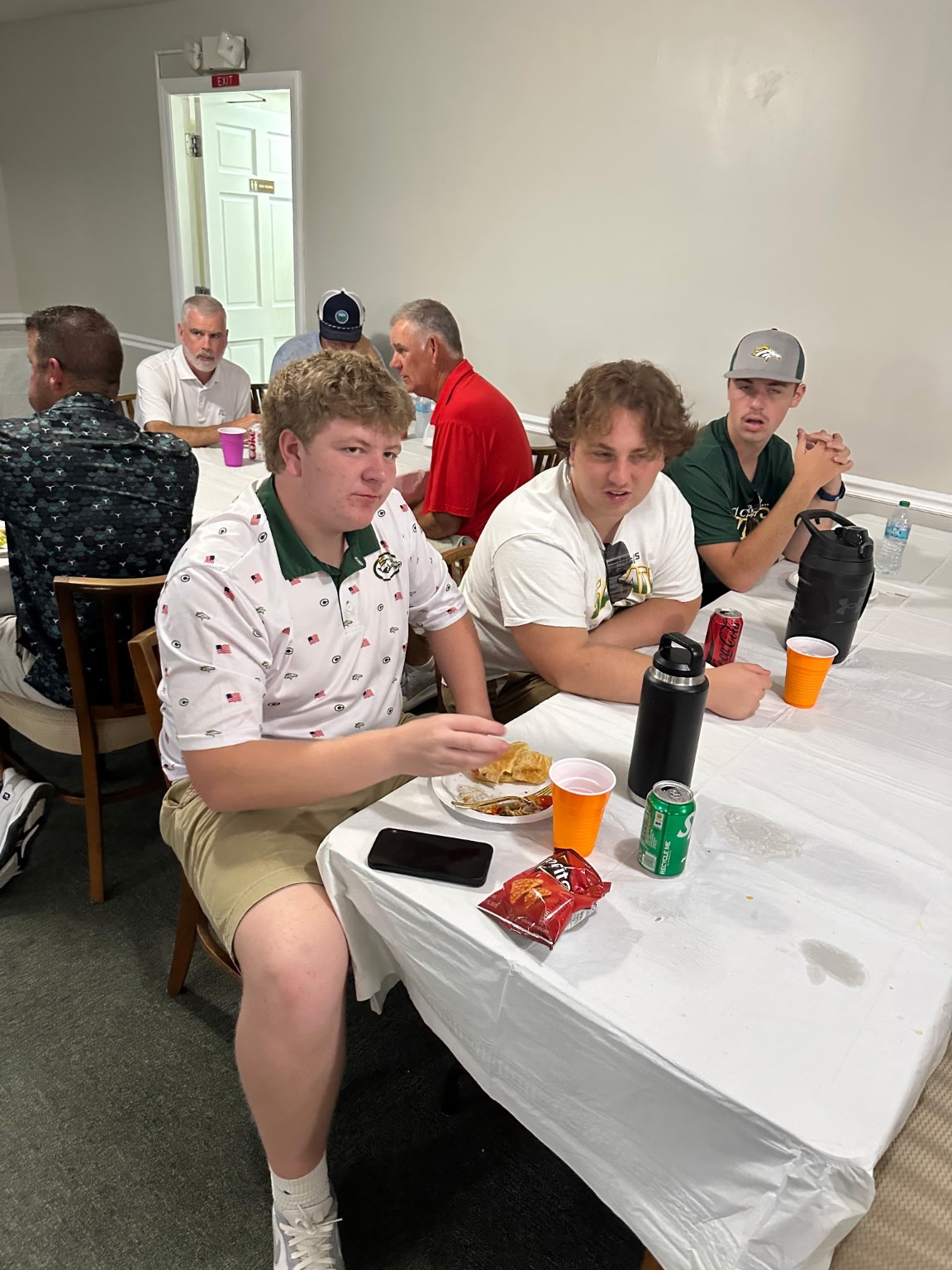Crest players and supporters seated during the golf tournament meal
